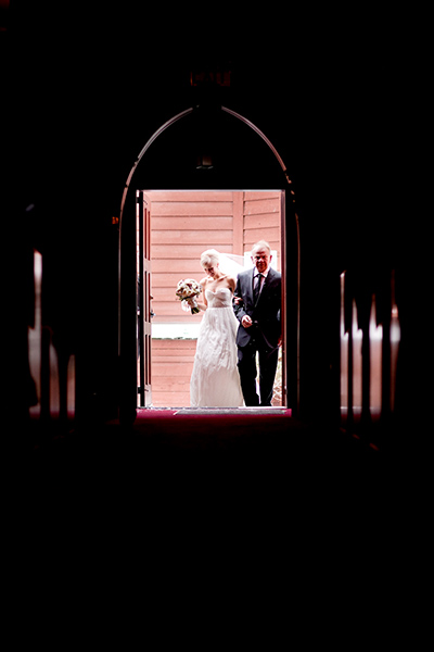 Framed by the church entrance :: Canmore Wedding Photography by infusedstudios.ca