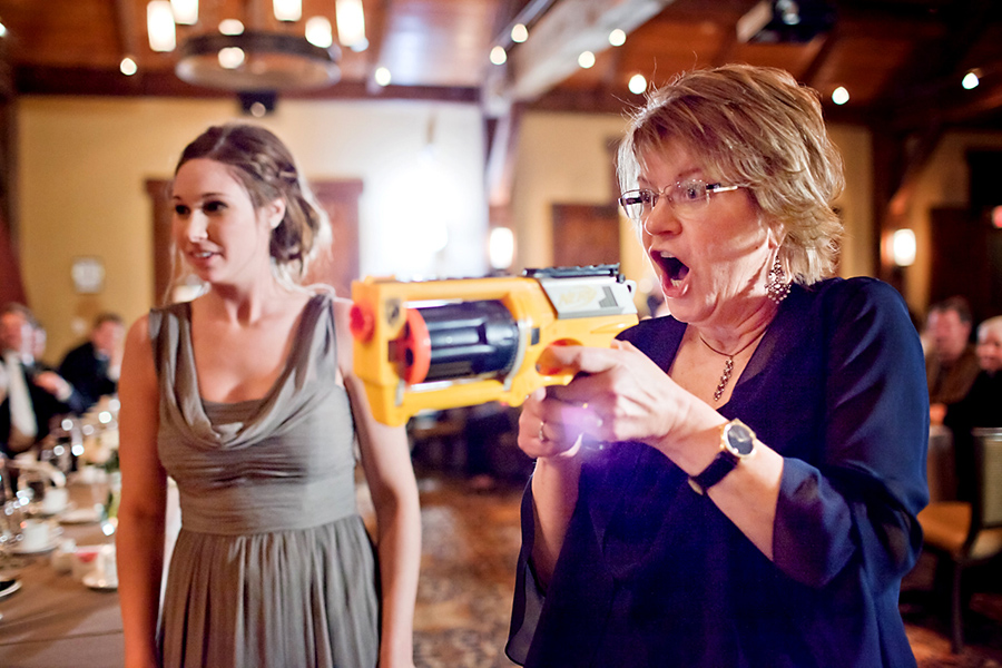Nerf gun at the reception - fun! :: Canmore Wedding Photography by infusedstudios.ca
