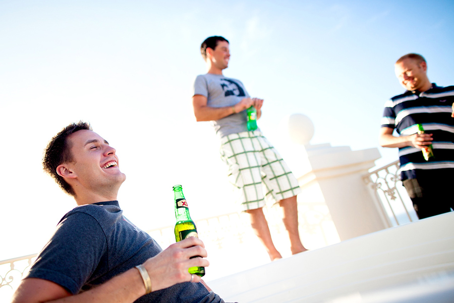 Guests relaxing with a beer :: Destination Wedding Photography by infusedstudios.ca