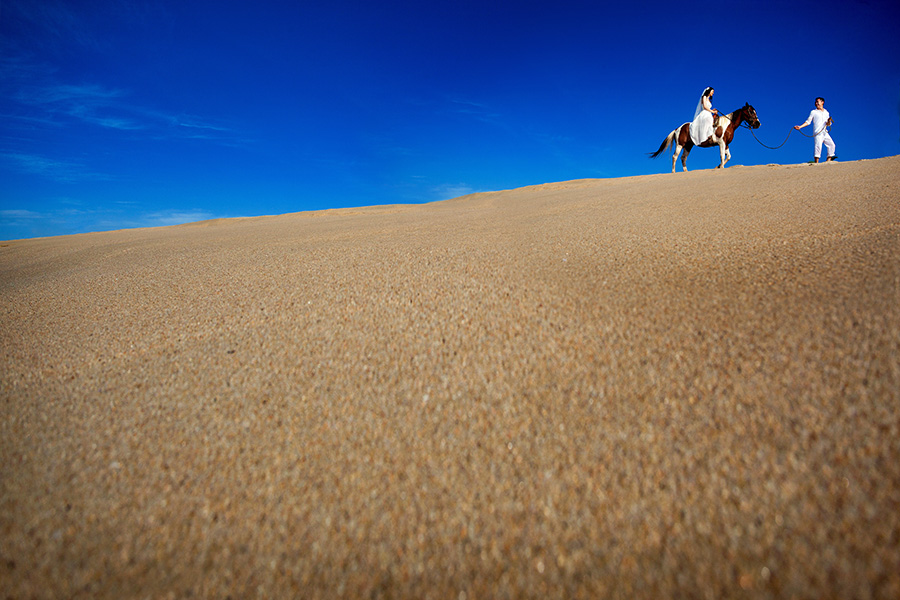 Horseback ride through the sand :: Destination Wedding Photography
