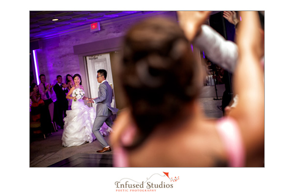 Bride and groom entering reception