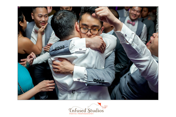 Groom and groomsmen hug it out