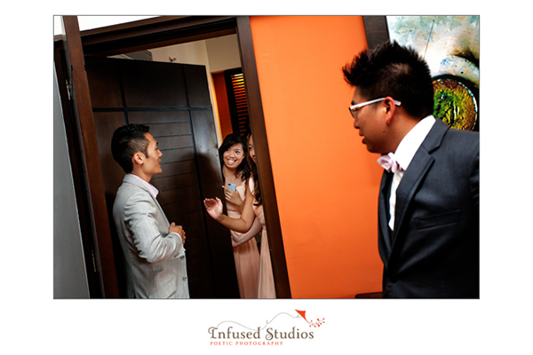 Groom being greeted by bridesmaid