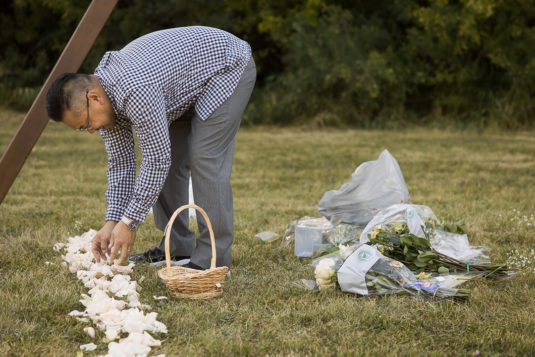 Edmonton family photo ideas - vow renewal groom creating aisle with rose petals