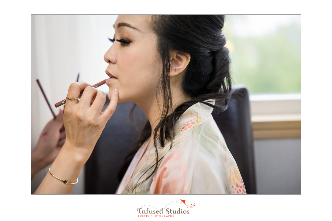 Bride having make up done by Calgary wedding photography by Infused Studios
