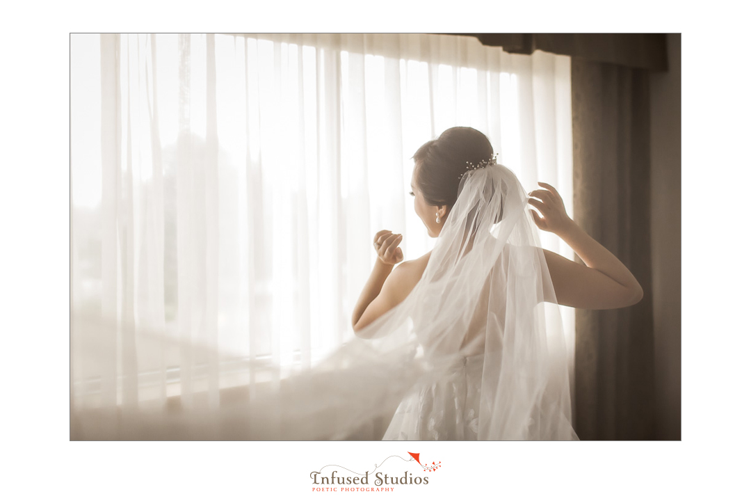 Bride wearing veil by Calgary wedding photography by Infused Studios
