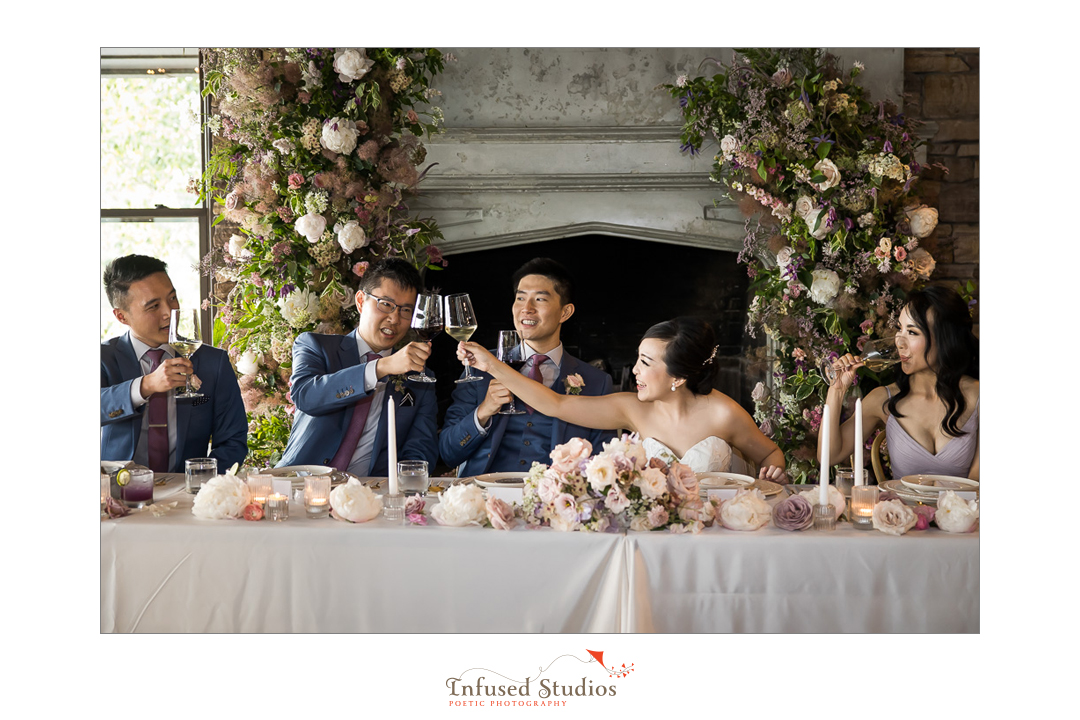Toasts at bridal table by Calgary wedding photographers Infused Studios