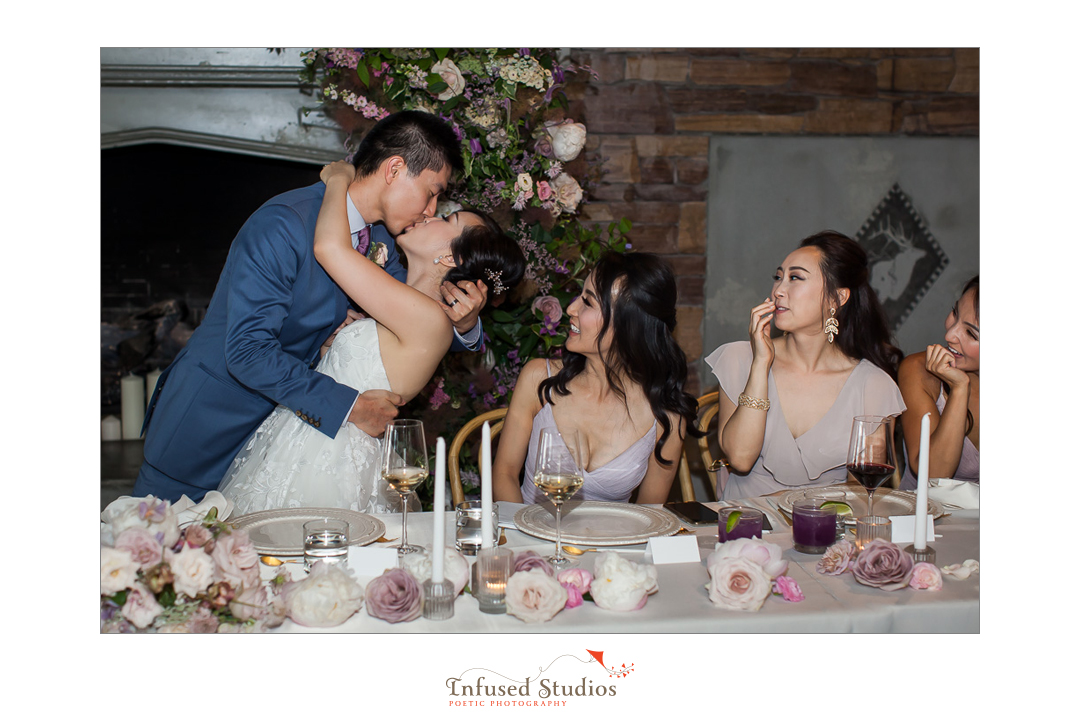 Bride & groom kiss during reception by Calgary wedding photographers Infused Studios